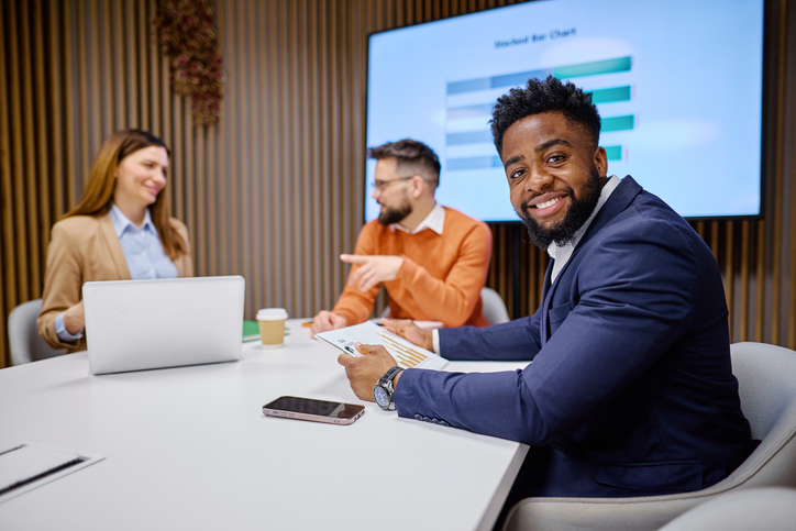Young businessman smiling during a meeting in a modern office