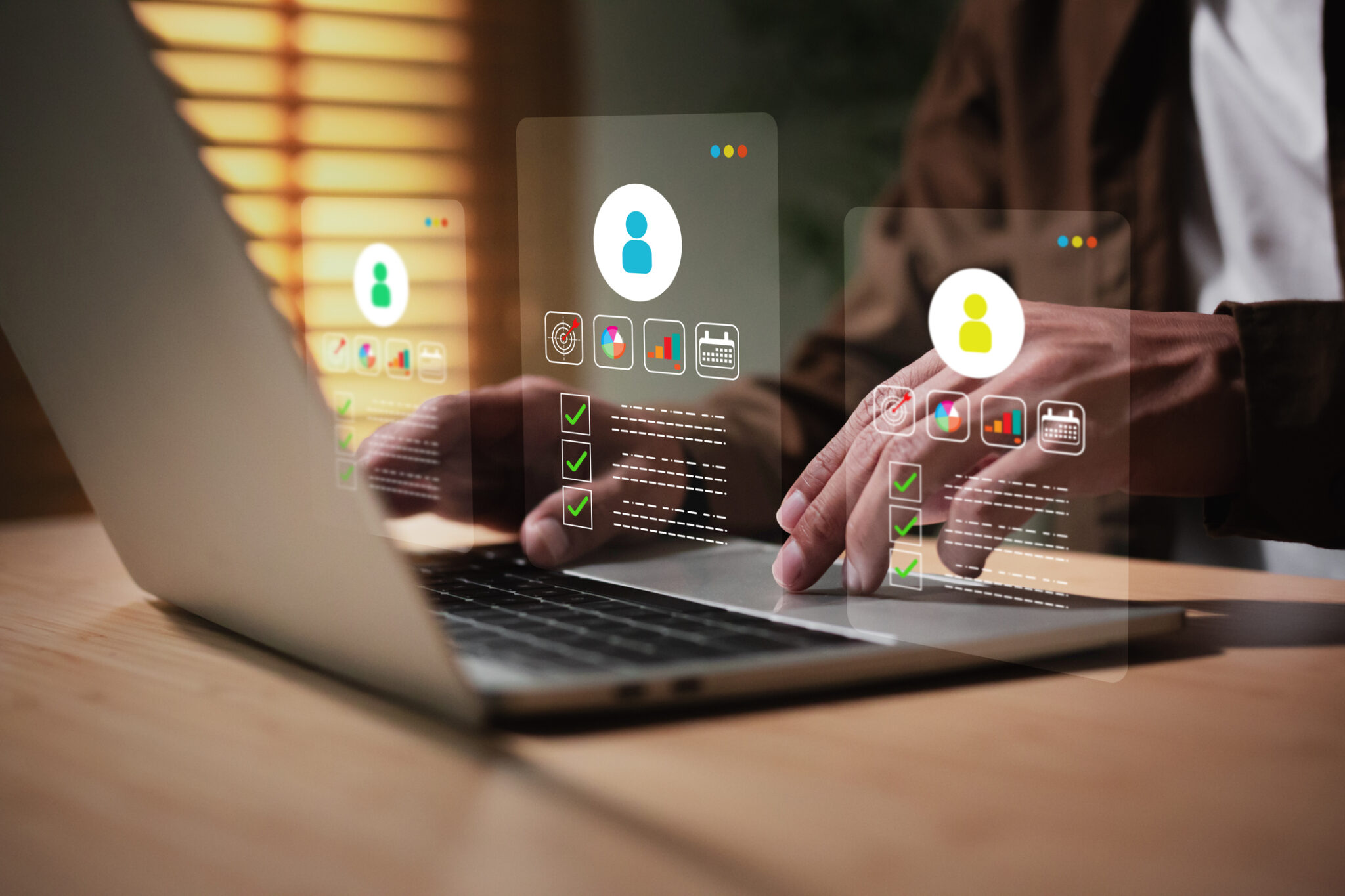 Man is working on a laptop, interacting with a holographic user interface displaying customer profiles or human resources (HR), Customer Relationship Management (CRM), and personal data management